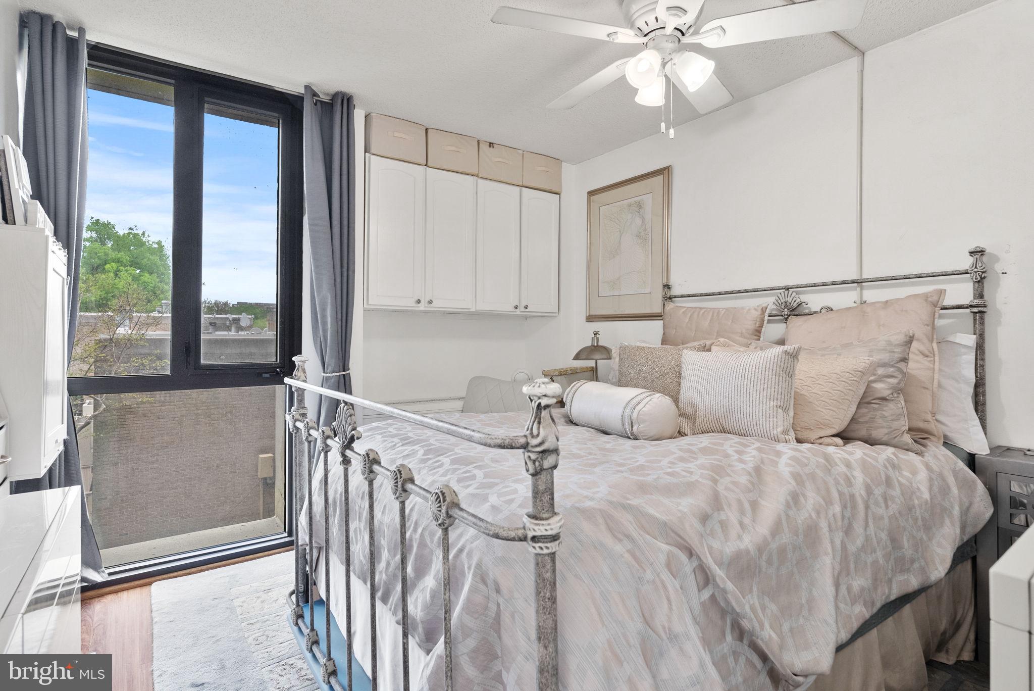 1250 4th Street Southwest, Unit W107 Washington, DC 20024 - Photo 20 of 30 a bed sitting in a bedroom next to a window