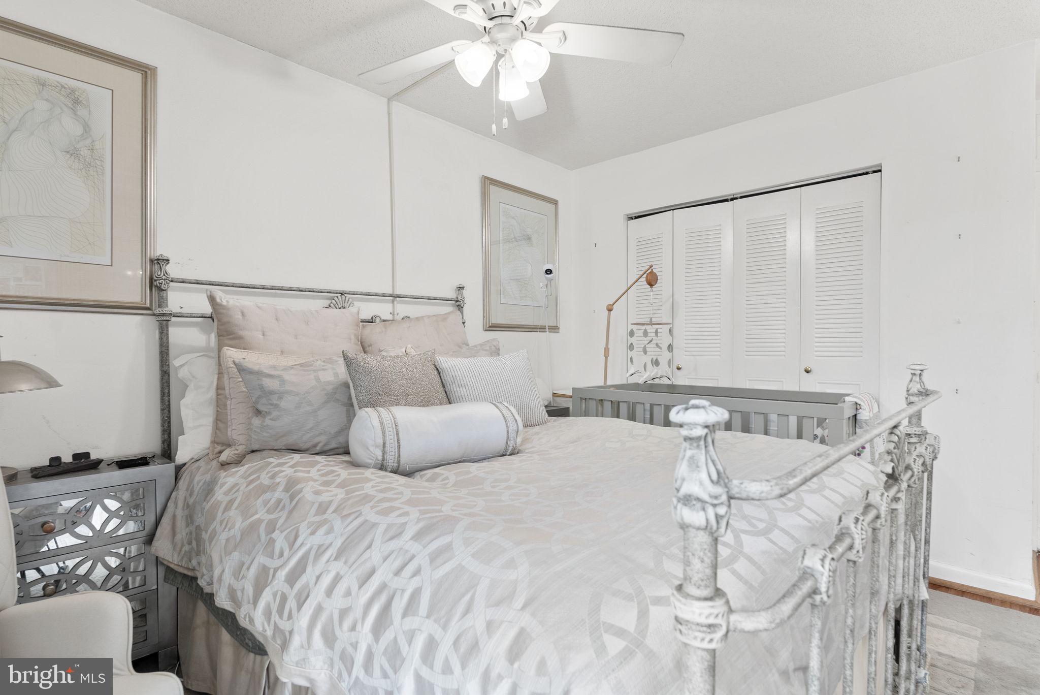 1250 4th Street Southwest, Unit W107 Washington, DC 20024 - Photo 22 of 30 a bedroom with a bed and ceiling fan