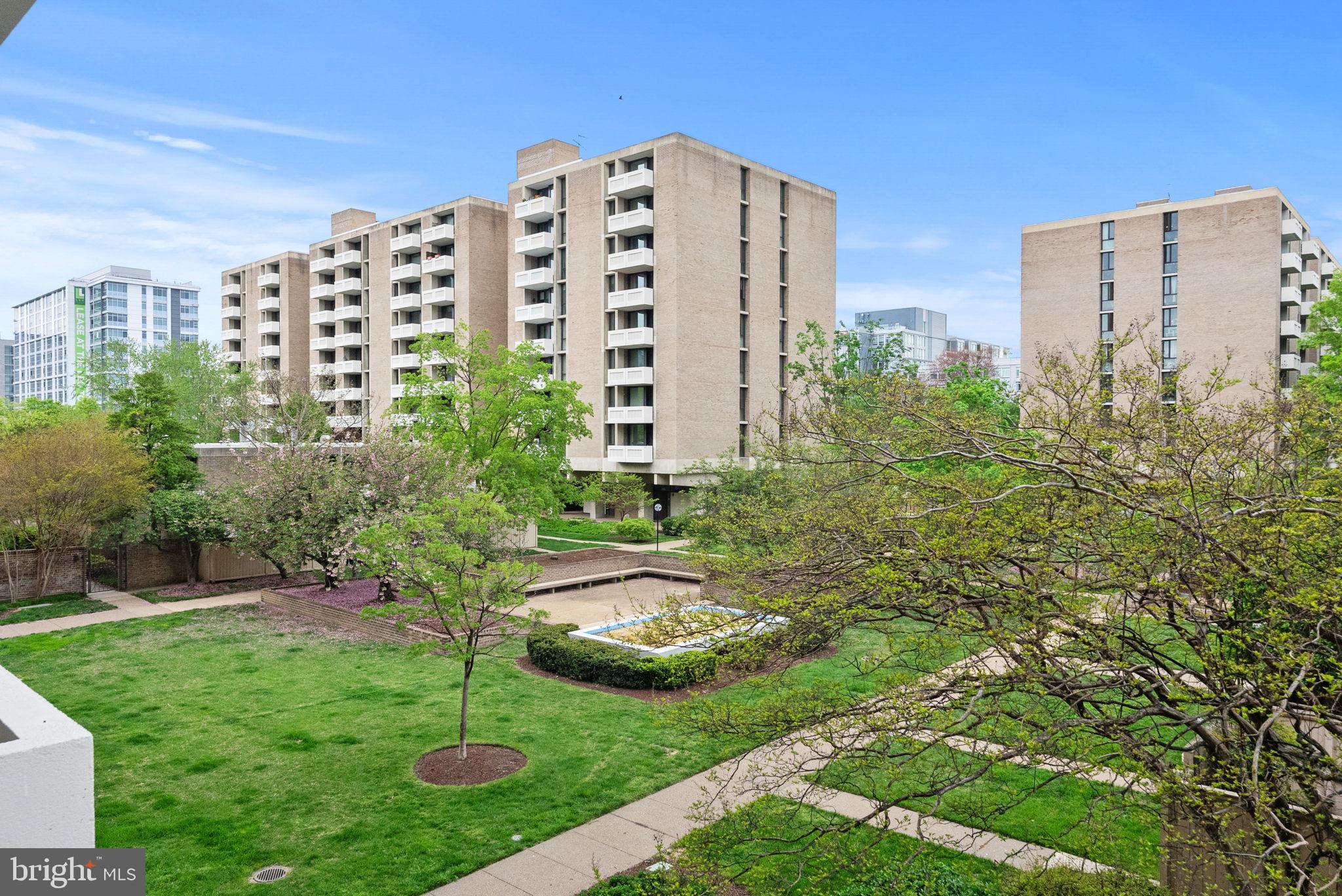 1250 4th Street Southwest, Unit W107 Washington, DC 20024 - Photo 27 of 30 a view of a tall building next to a yard
