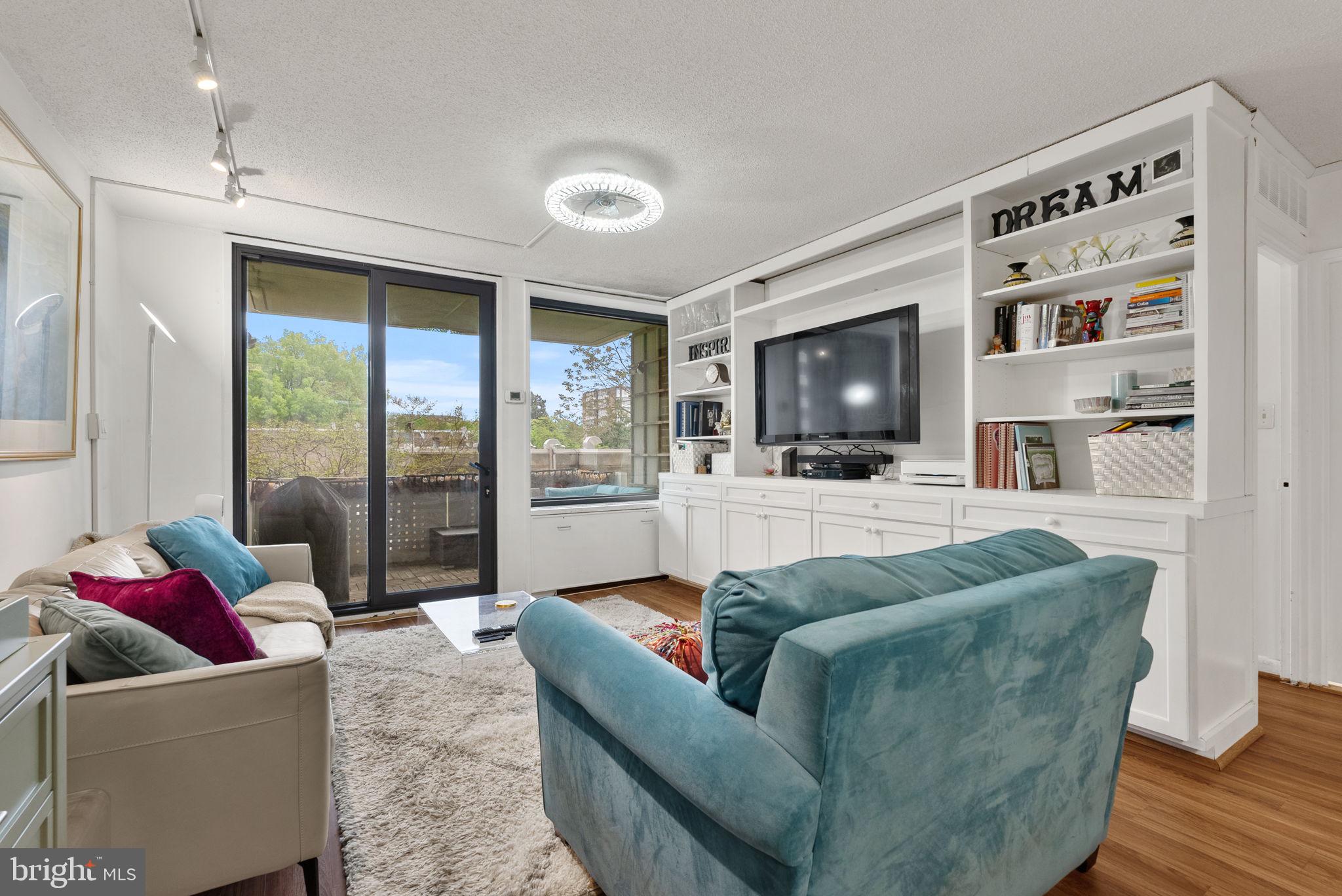 1250 4th Street Southwest, Unit W107 Washington, DC 20024 - Photo 9 of 30 a living room with furniture window and a flat screen tv