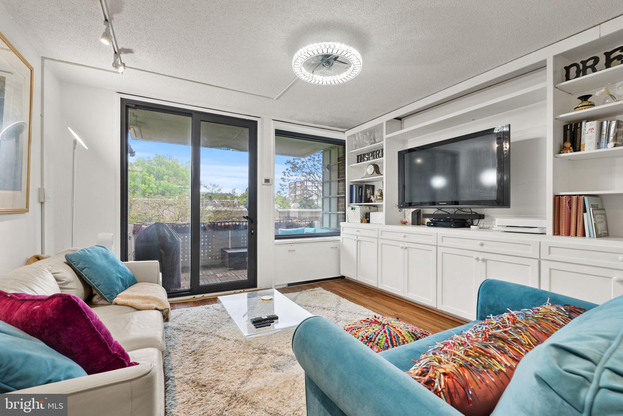 1250 4th Street Southwest, Unit W107 Washington, DC 20024 - Photo 10 of 30 a living room with furniture and a flat screen tv