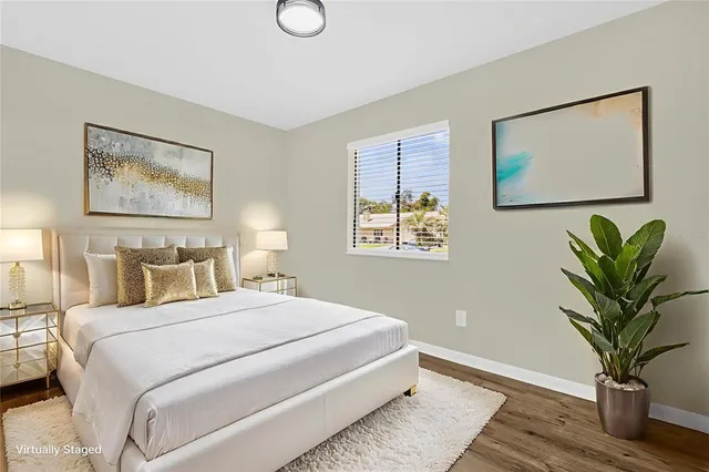 a bedroom with bed and a potted plant