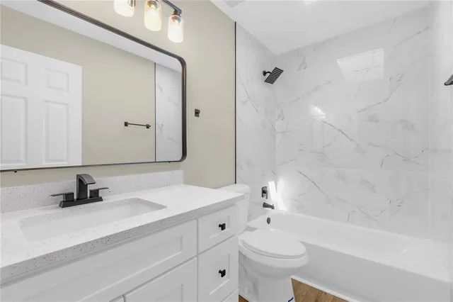 a bathroom with a sink a toilet and a bathtub