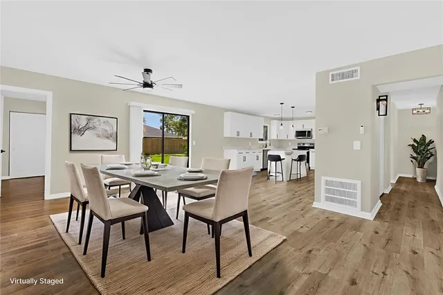 a dining room with furniture and wooden floor