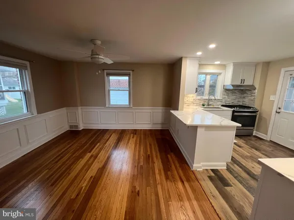 a kitchen with a cabinets and wooden floor