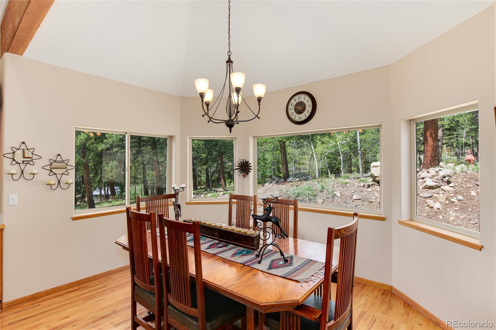 1211 Hughesville Road Black Hawk, CO 80422 - Photo 14 of 39 a view of a dining room with furniture a chandelier and wooden floor