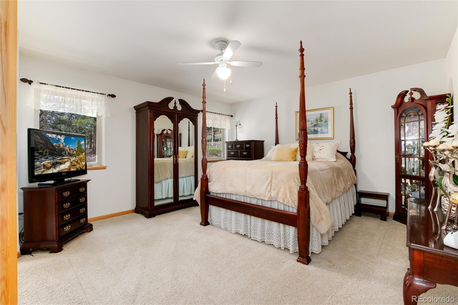 1211 Hughesville Road Black Hawk, CO 80422 - Photo 18 of 39 a bedroom with a bed and a flat tv screen on dresser