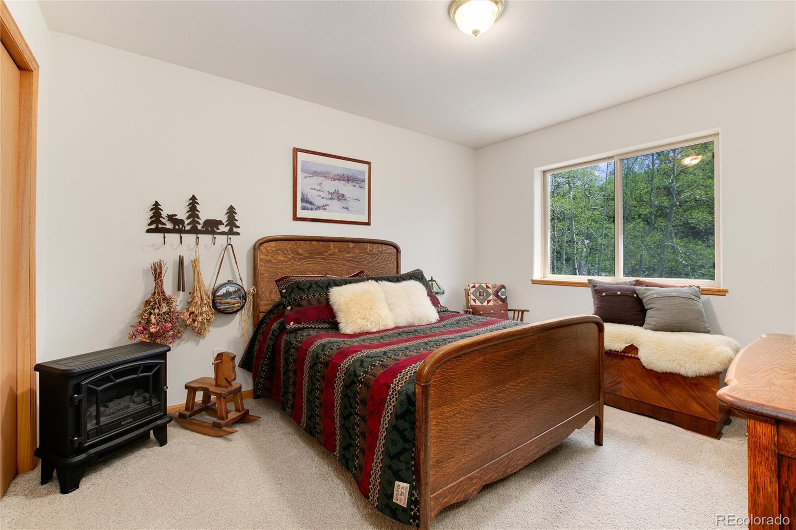 1211 Hughesville Road Black Hawk, CO 80422 - Photo 22 of 39 a bedroom with a bed and a window