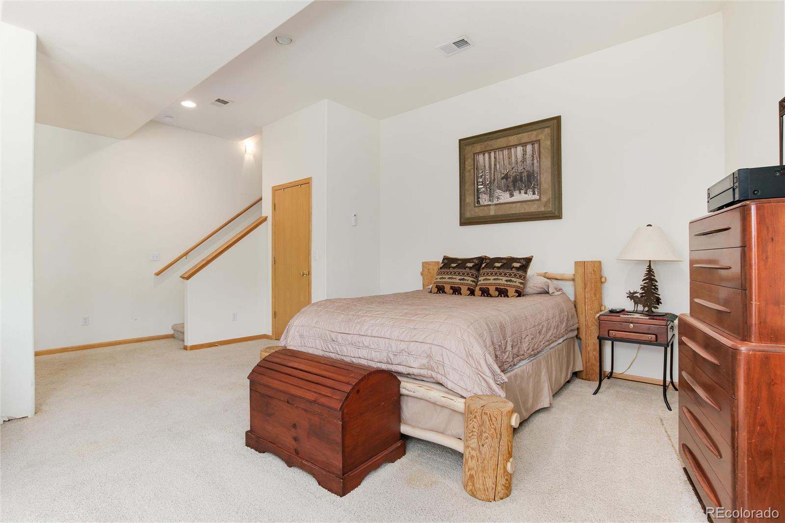 1211 Hughesville Road Black Hawk, CO 80422 - Photo 28 of 39 a bedroom with a bed and a flat screen tv