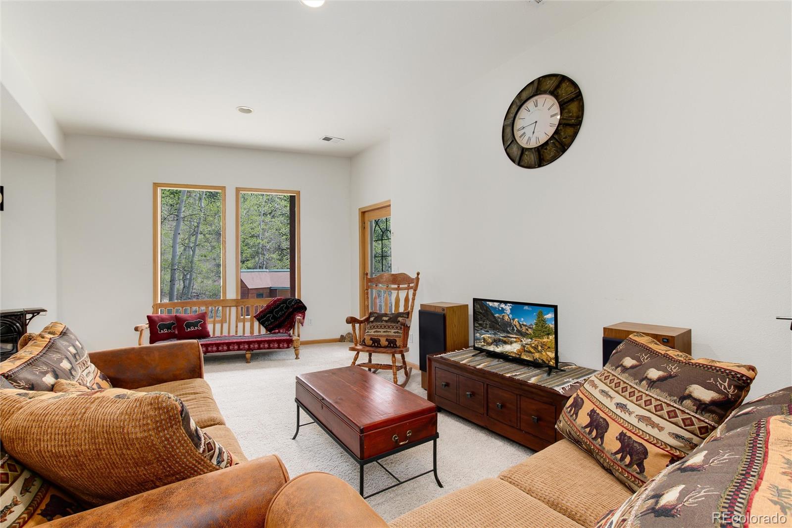1211 Hughesville Road Black Hawk, CO 80422 - Photo 30 of 39 a living room with furniture a rug and a window