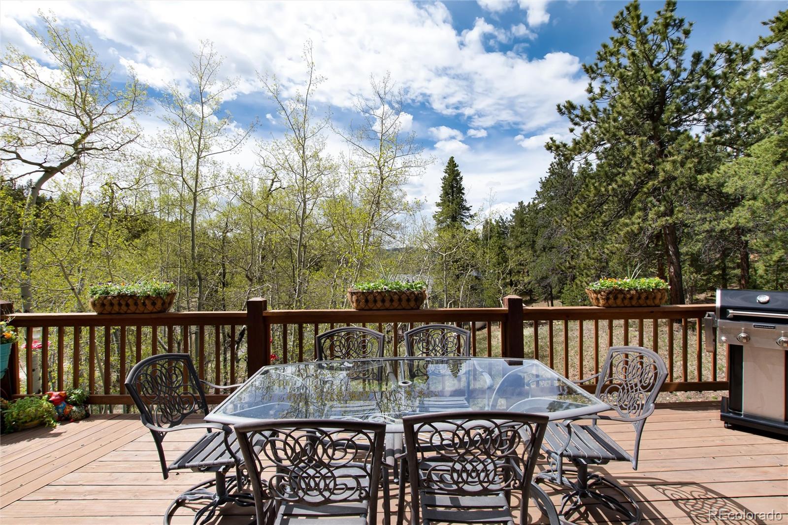 1211 Hughesville Road Black Hawk, CO 80422 - Photo 32 of 39 a view of a table and chairs on the roof deck