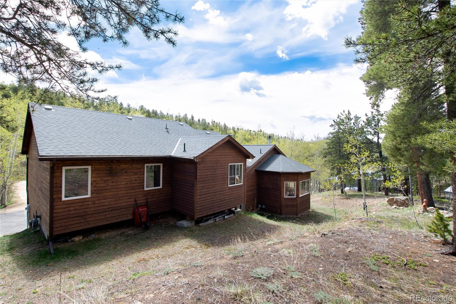 1211 Hughesville Road Black Hawk, CO 80422 - Photo 39 of 39 a view of a house with a yard