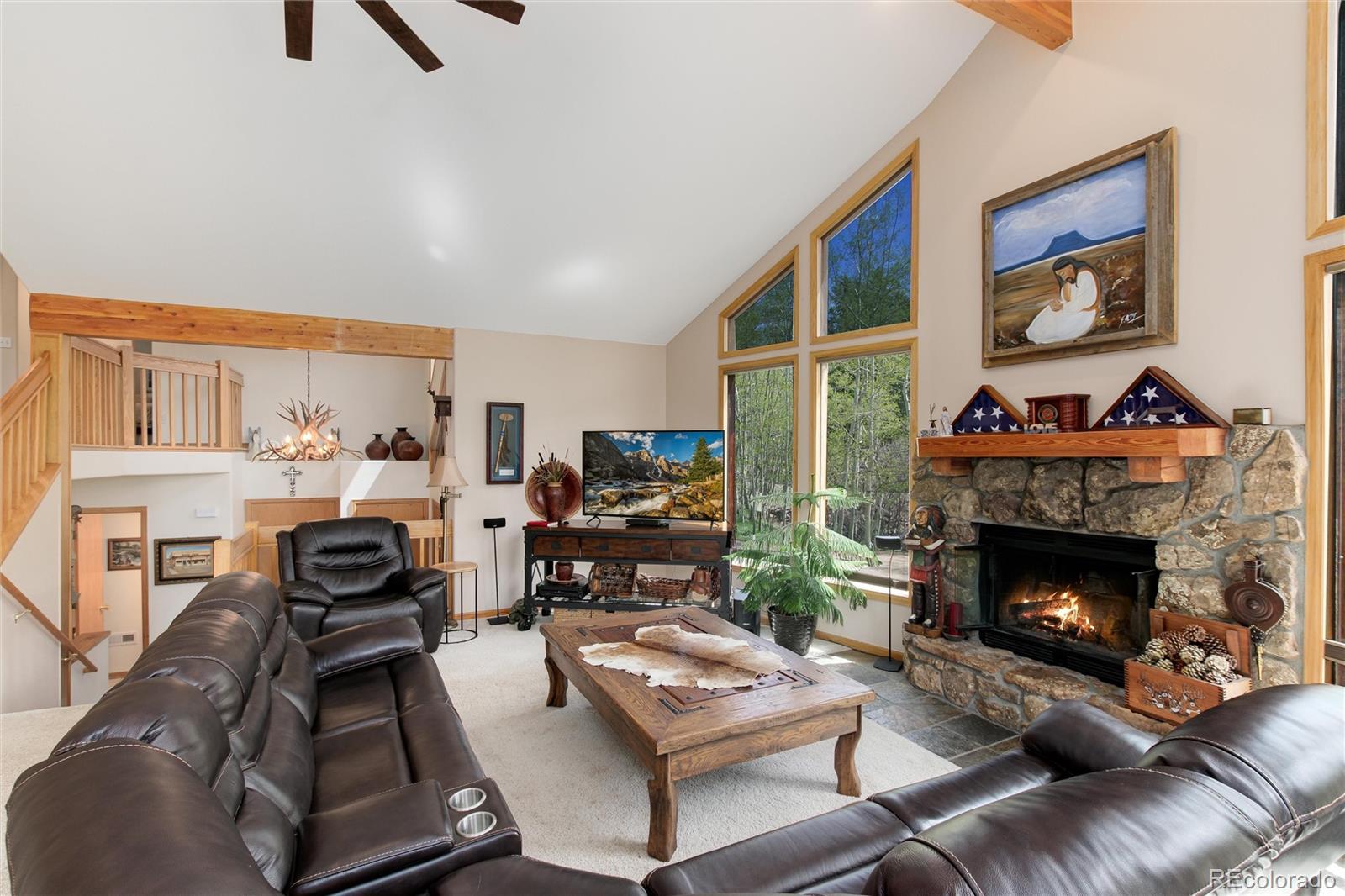 1211 Hughesville Road Black Hawk, CO 80422 - Photo 8 of 39 a living room with furniture and a fireplace