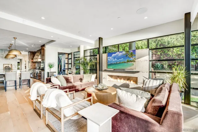 a living room with furniture large windows and a flat screen tv