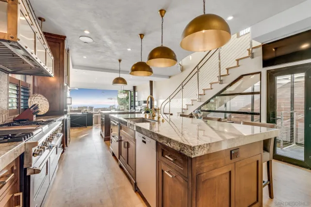 a kitchen with stainless steel appliances granite countertop a sink and a stove