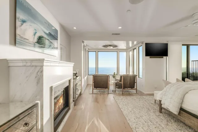 a bedroom with furniture and a fireplace