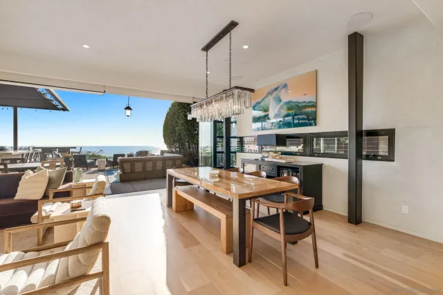 a living room with stainless steel appliances kitchen island granite countertop furniture and a floor to ceiling window
