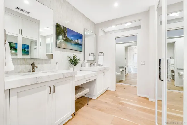 a bedroom with a large bed and a flat screen tv