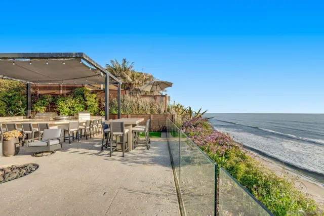 a view of a patio with chairs and table