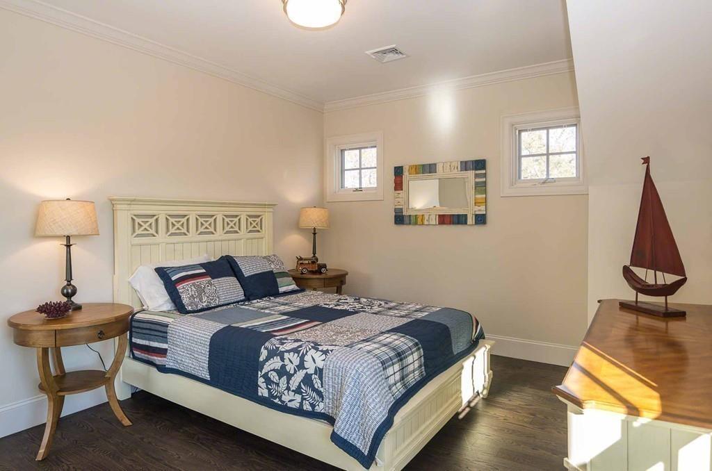 6 Nora's Lane Edgartown, MA 02539 - Photo 21 of 30 a bedroom with a bed and wooden floor