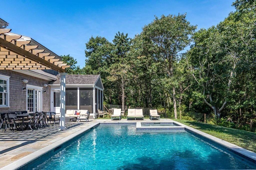 6 Nora's Lane Edgartown, MA 02539 - Photo 3 of 30 a view of swimming pool with lawn chairs and plants