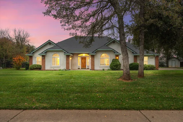 a front view of a house with a garden