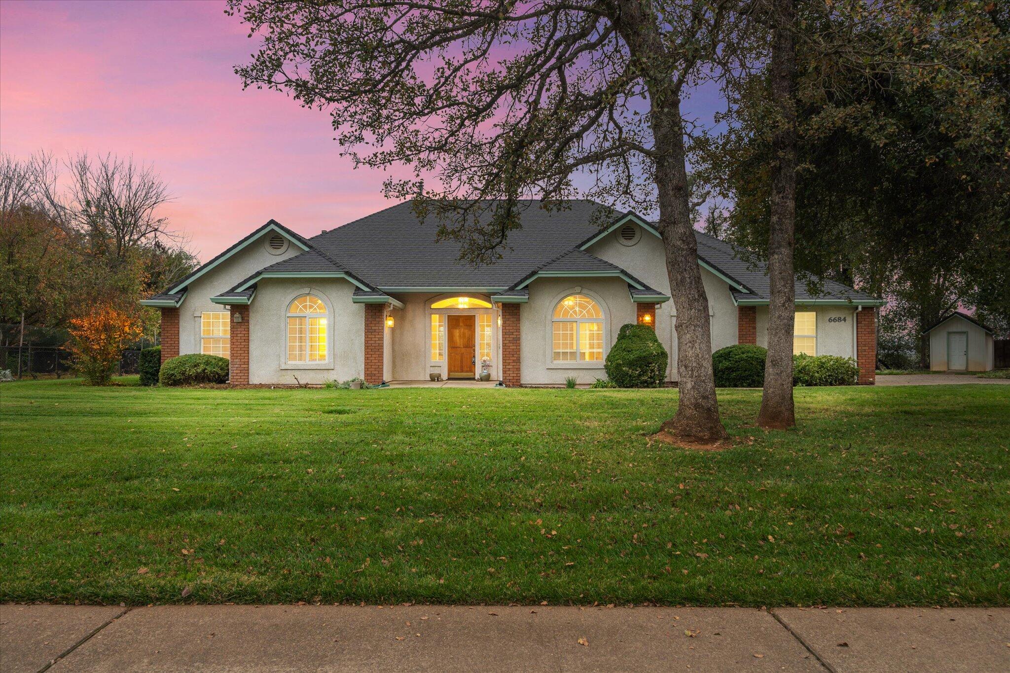 a front view of a house with a garden