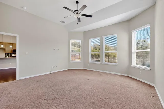 a view of empty room with a ceiling fan