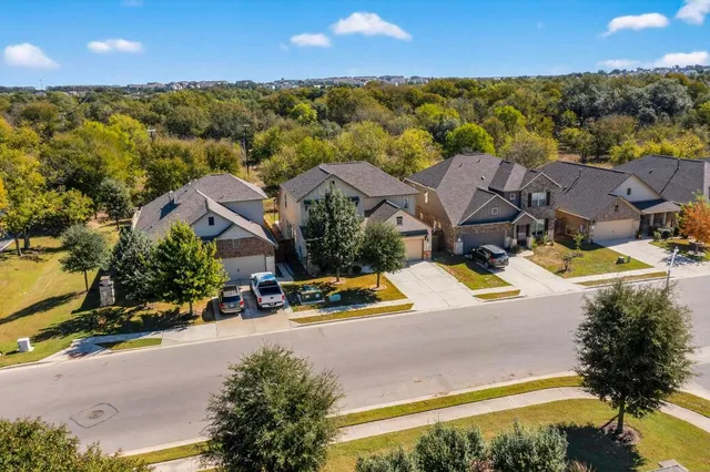 an aerial view of residential houses with outdoor space