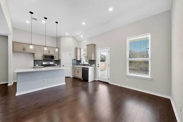 a view of a kitchen with a sink and a window