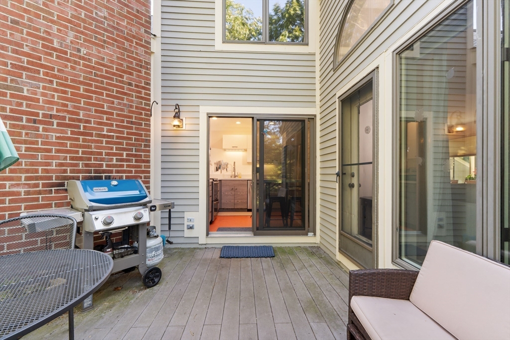 26 Quarry Ridge Lane, Unit 26 Rockport, MA 01966 - Photo 11 of 37 a balcony with furniture and wooden floor