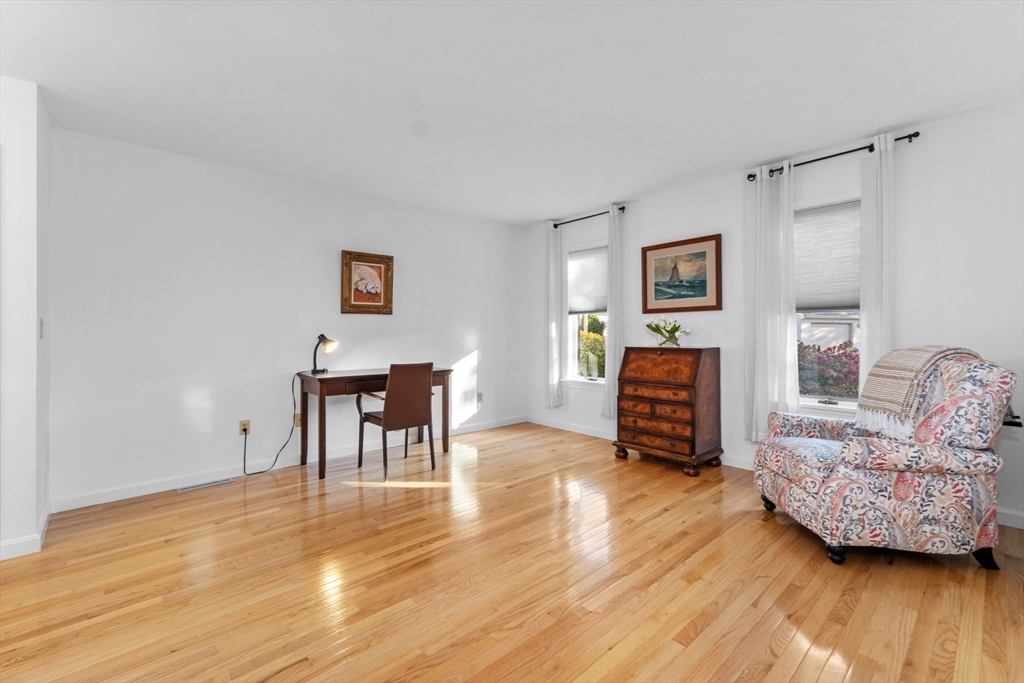 26 Quarry Ridge Lane, Unit 26 Rockport, MA 01966 - Photo 13 of 37 a living room with furniture and a wooden floor
