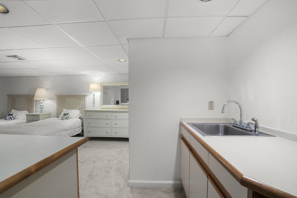 26 Quarry Ridge Lane, Unit 26 Rockport, MA 01966 - Photo 25 of 37 a room with a bed and a dresser