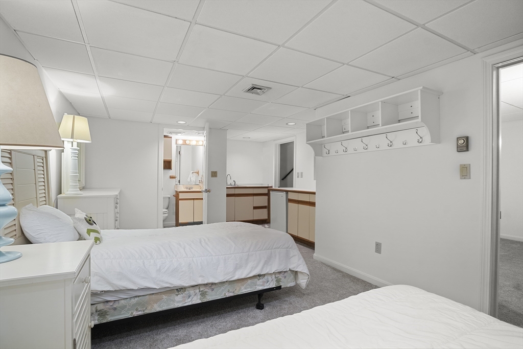 26 Quarry Ridge Lane, Unit 26 Rockport, MA 01966 - Photo 26 of 37 a spacious bedroom with a bed and cabinet