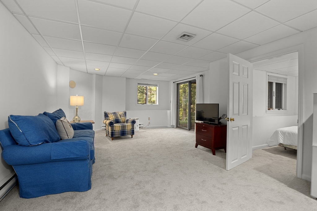 26 Quarry Ridge Lane, Unit 26 Rockport, MA 01966 - Photo 28 of 37 a living room with furniture and a flat screen tv