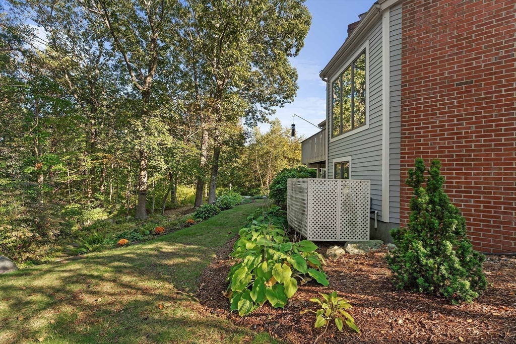 26 Quarry Ridge Lane, Unit 26 Rockport, MA 01966 - Photo 33 of 37 a view of a garden with plants and large trees