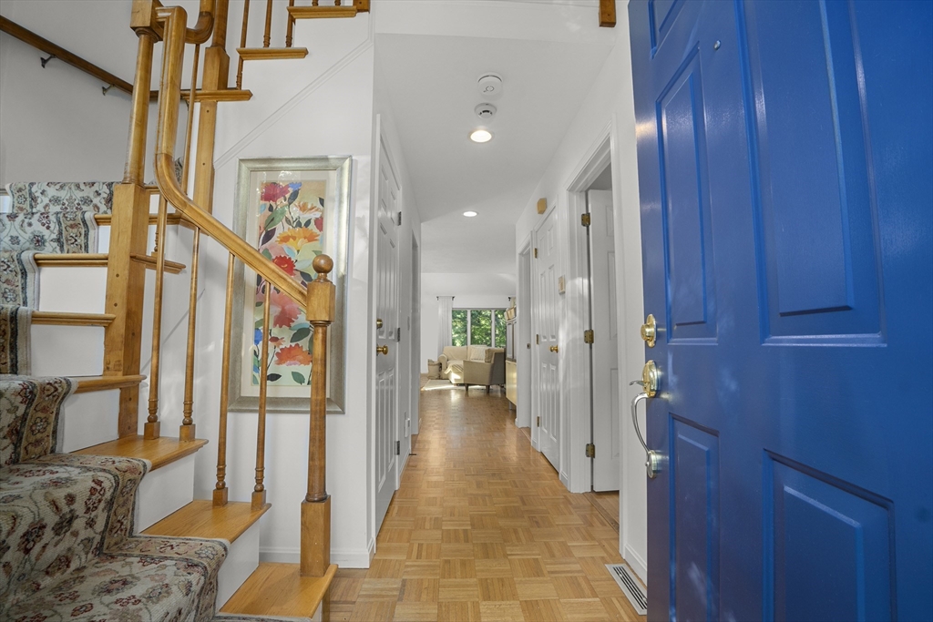 26 Quarry Ridge Lane, Unit 26 Rockport, MA 01966 - Photo 4 of 37 a view of hallway with furniture and a chandelier