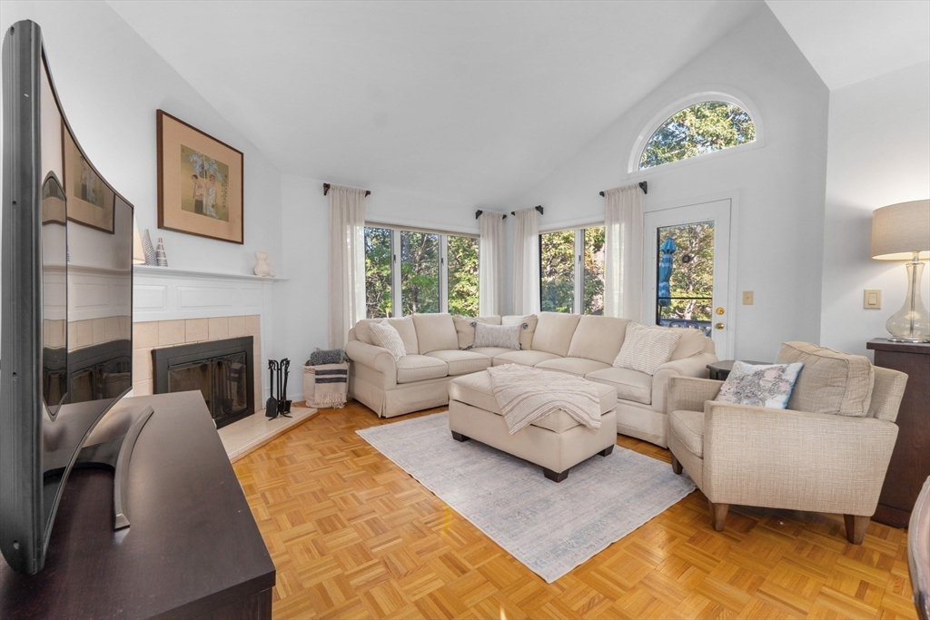 26 Quarry Ridge Lane, Unit 26 Rockport, MA 01966 - Photo 7 of 37 a living room with furniture and a fireplace