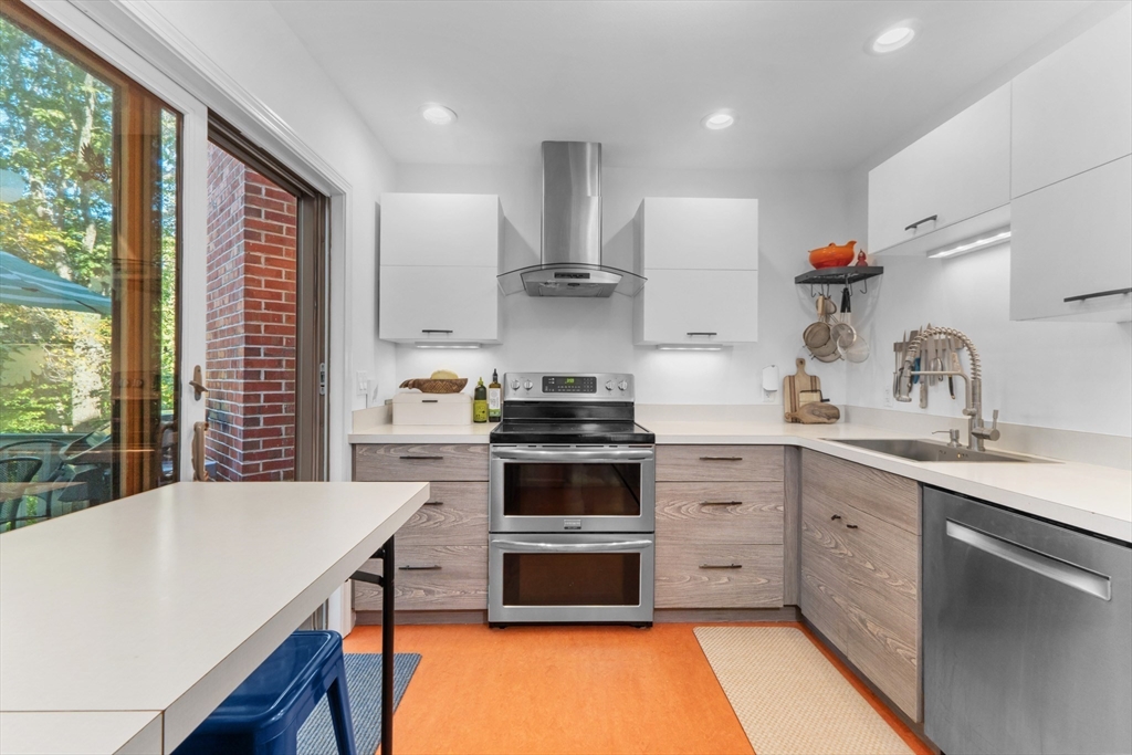 26 Quarry Ridge Lane, Unit 26 Rockport, MA 01966 - Photo 9 of 37 a kitchen with stainless steel appliances a stove sink and cabinets