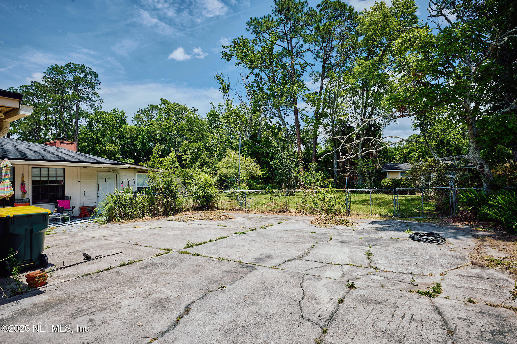 8965 San Rae Road Jacksonville, FL 32257 - Photo 43 of 46 a view of a backyard with a table and chairs under an umbrella