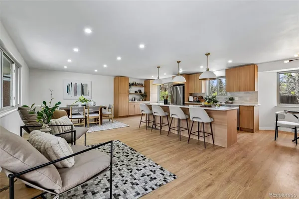 a living room with lots of furniture and kitchen view