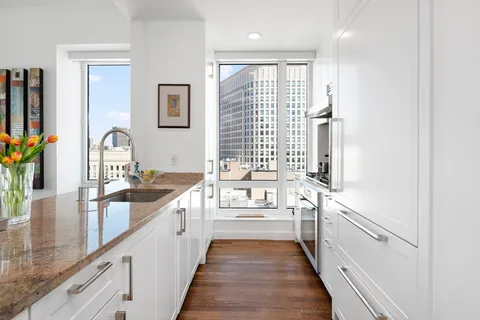 a view of a kitchen with a sink and a wooden floor