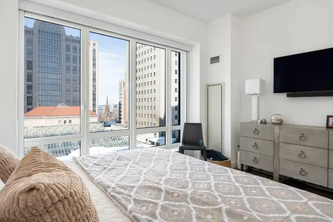 a bedroom with a bed and a flat screen tv