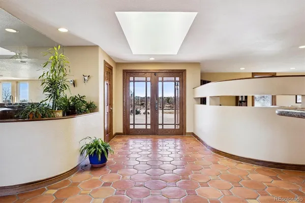 a living room with furniture fireplace and a large window