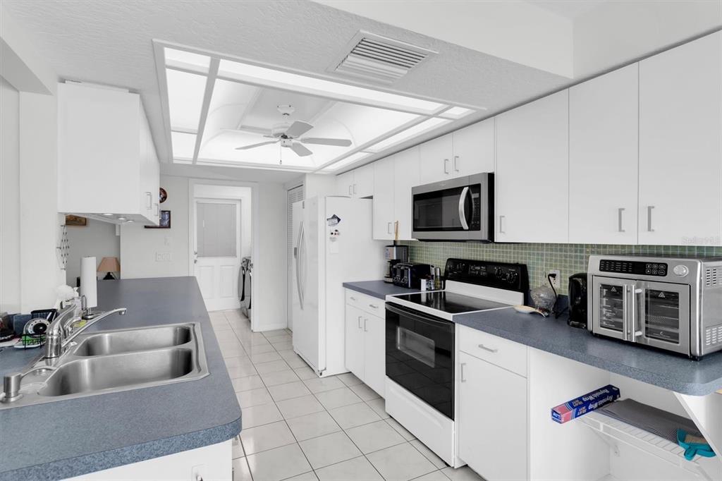 9052 Arundle Place New Port Richey, FL 34655 - Photo 10 of 57 a kitchen with a stove and a microwave