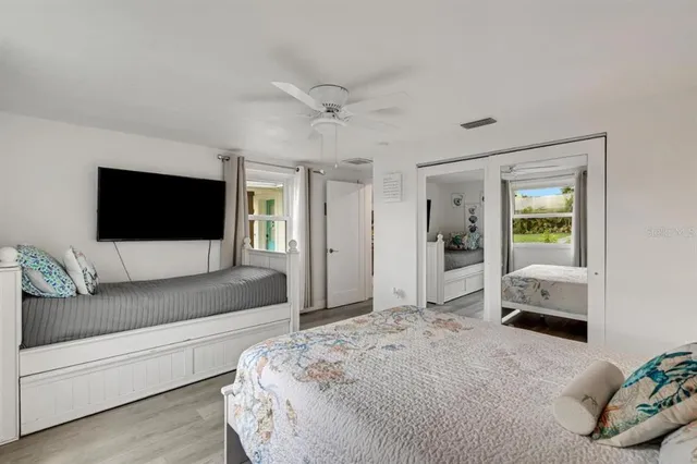 a bathroom with a granite countertop sink mirror vanity and toilet