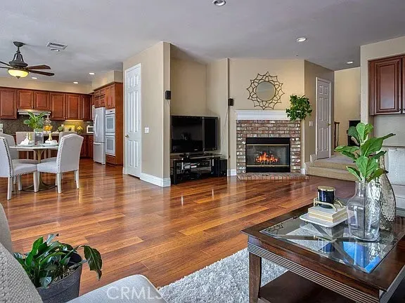 a living room with furniture fireplace and potted plants