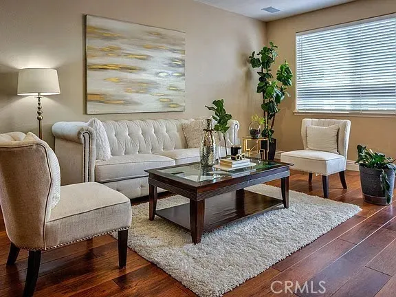 a living room with furniture and a potted plant