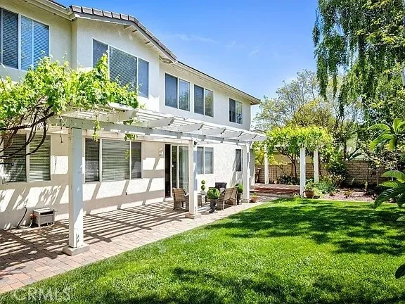 a front view of a house with a yard table and chairs