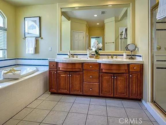 a spacious bathroom with a granite countertop tub sink and mirror